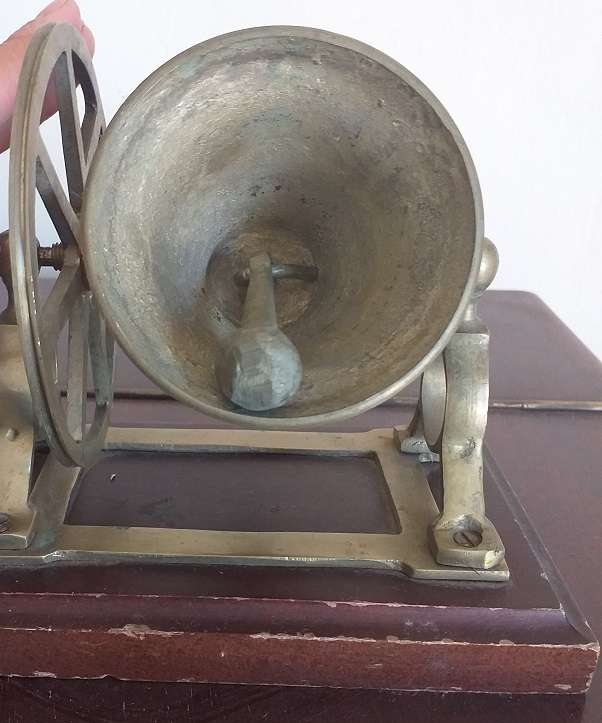 Antique brass bell mounted on wooden plate