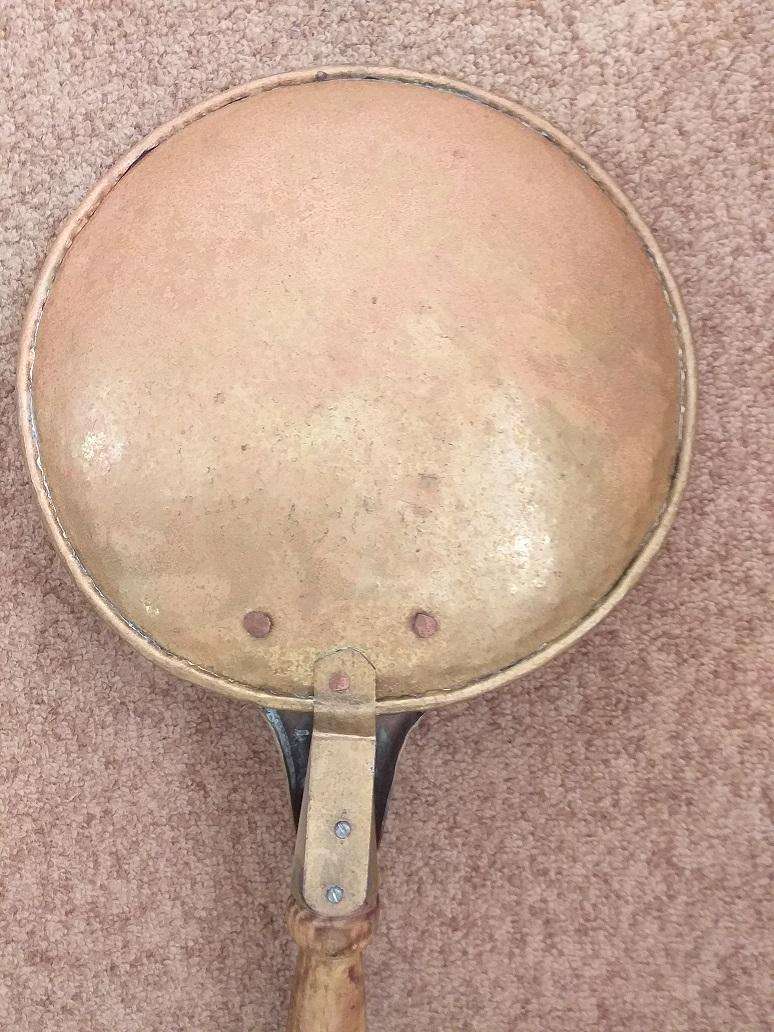 Large antique copper ladle with wooden handle
