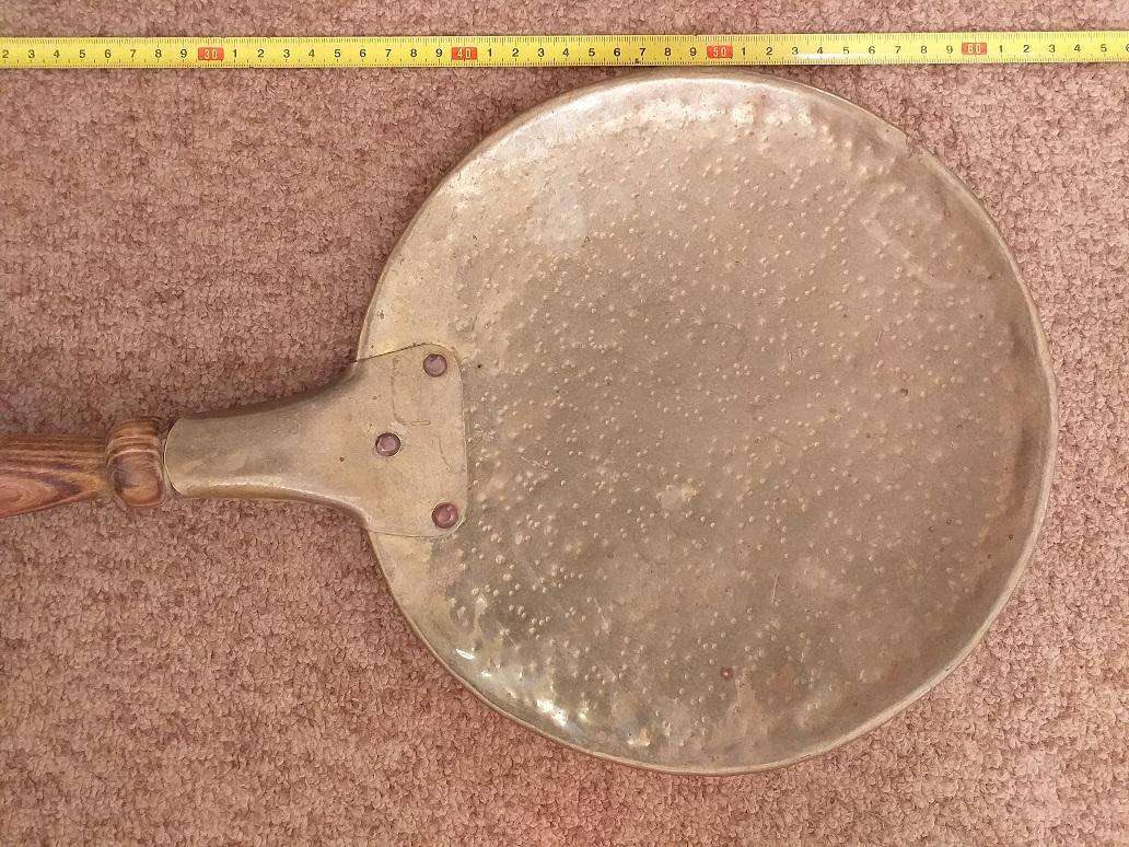 Large antique copper ladle with wooden handle