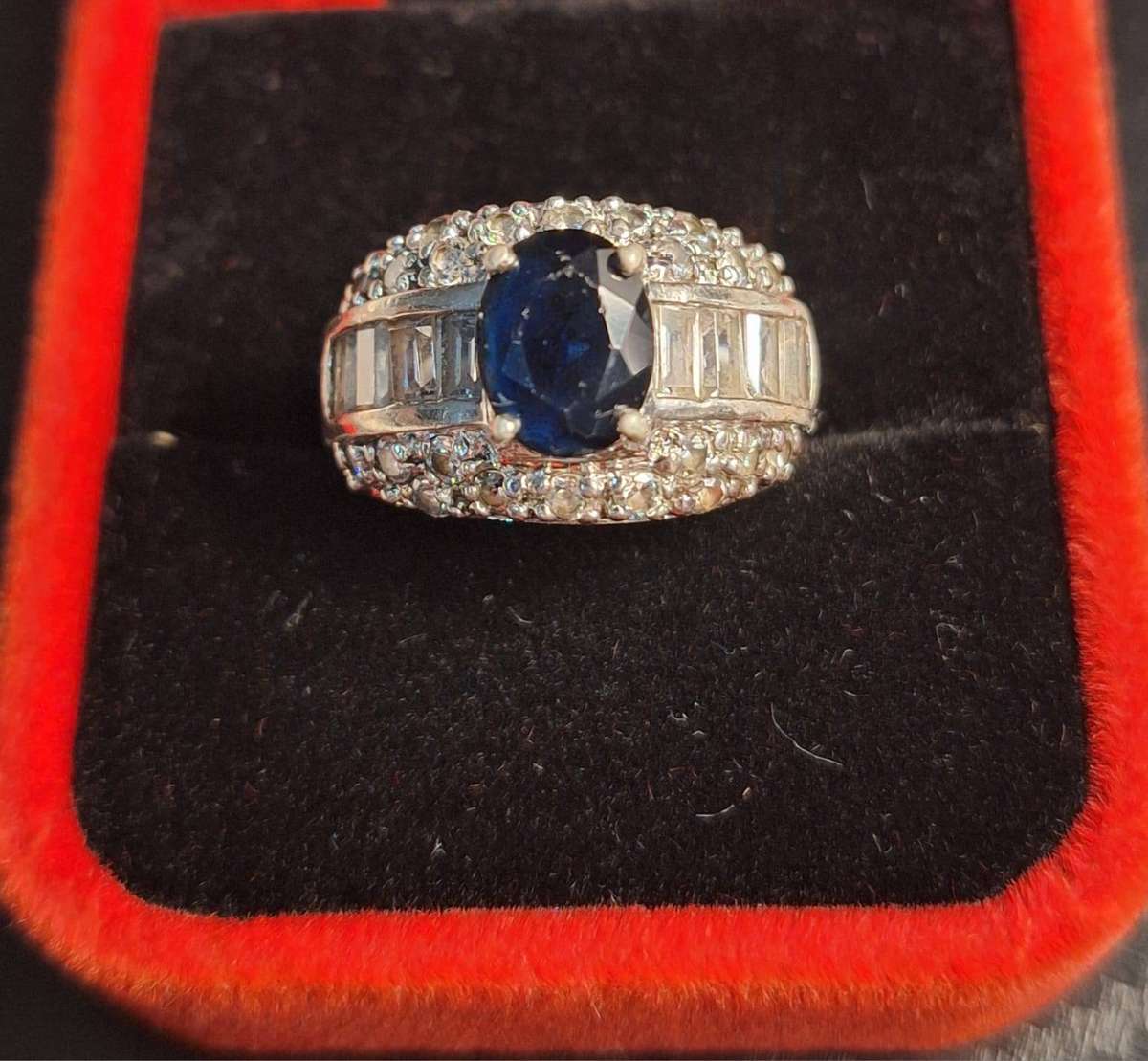 Blue Silver Ring features a prominent oval-cut center stone surrounded by other