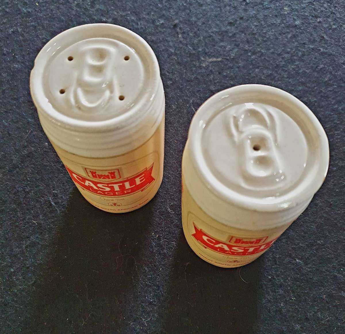 VINTAGE CASTLE LAGER BIG PORCELAIN SALT AND PEPPER SHAKERS.