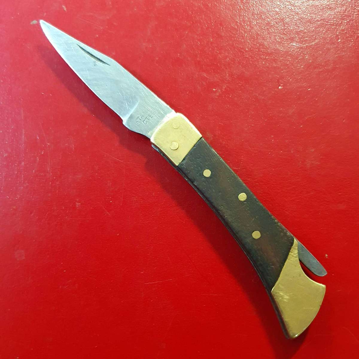 VINTAGE STAINLESS AND BRASS WITH WOOD FOLDING KNIFE.