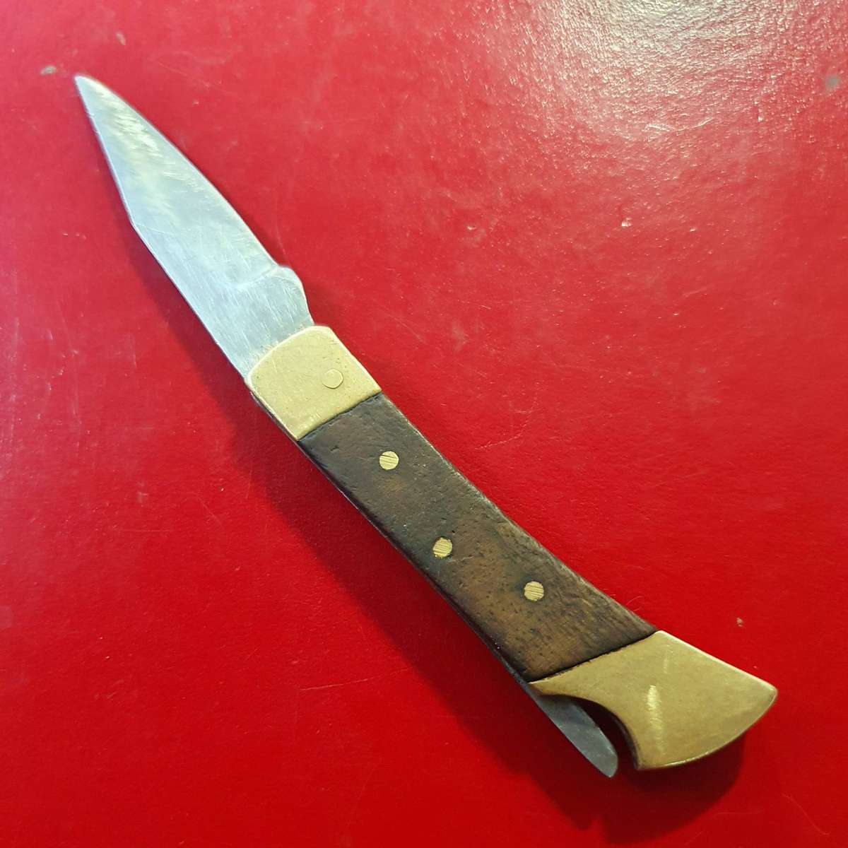 VINTAGE STAINLESS AND BRASS WITH WOOD FOLDING KNIFE.