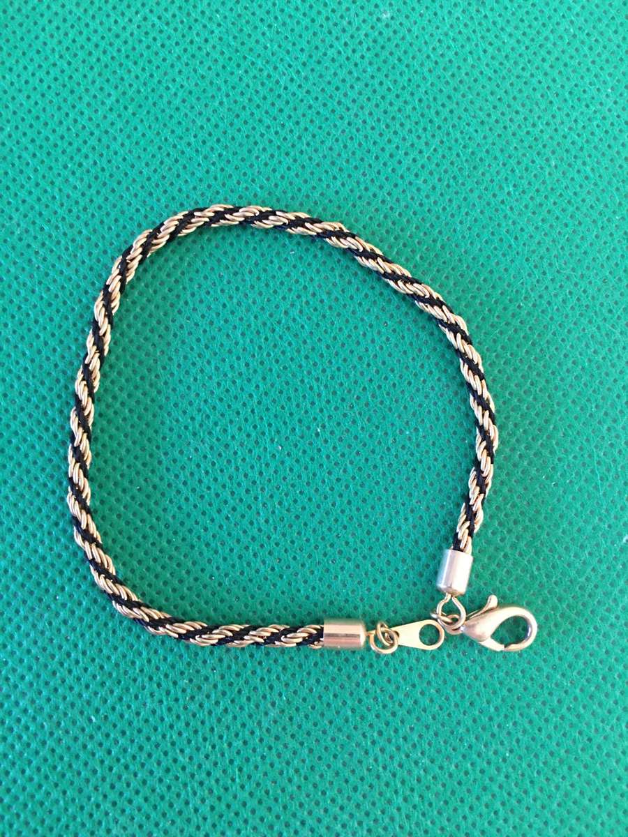 LOVELY GOLD TONE AND TIFARI CORD BRACELET
