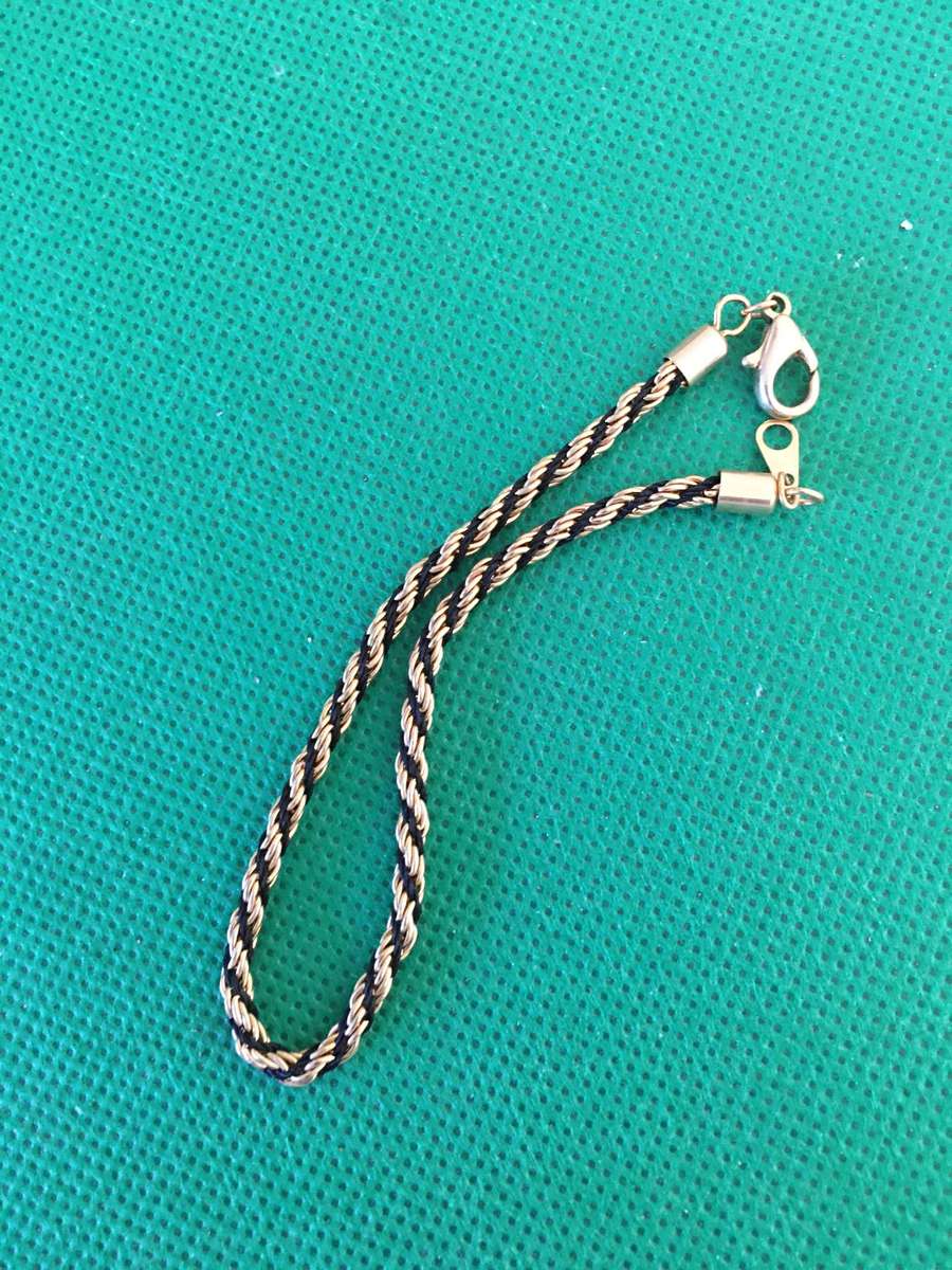 LOVELY GOLD TONE AND TIFARI CORD BRACELET