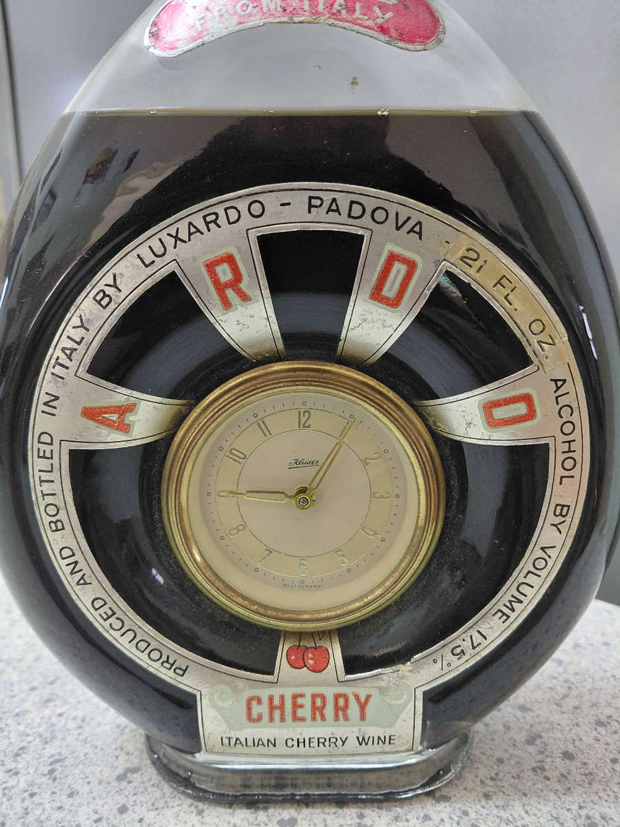 Luxardo Italian Cherry Wine bottle with an integrated clock in working condition