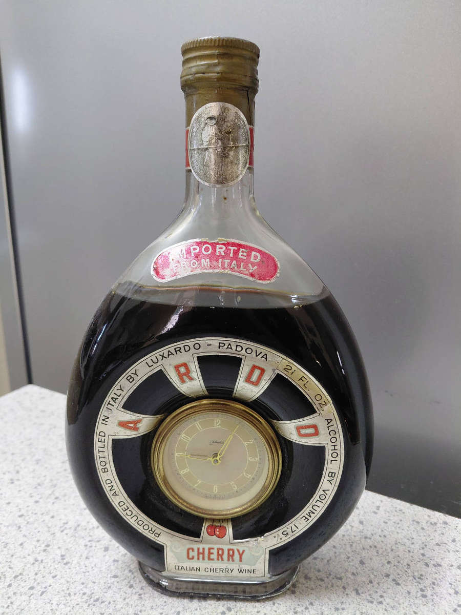 Luxardo Italian Cherry Wine bottle with an integrated clock in working condition