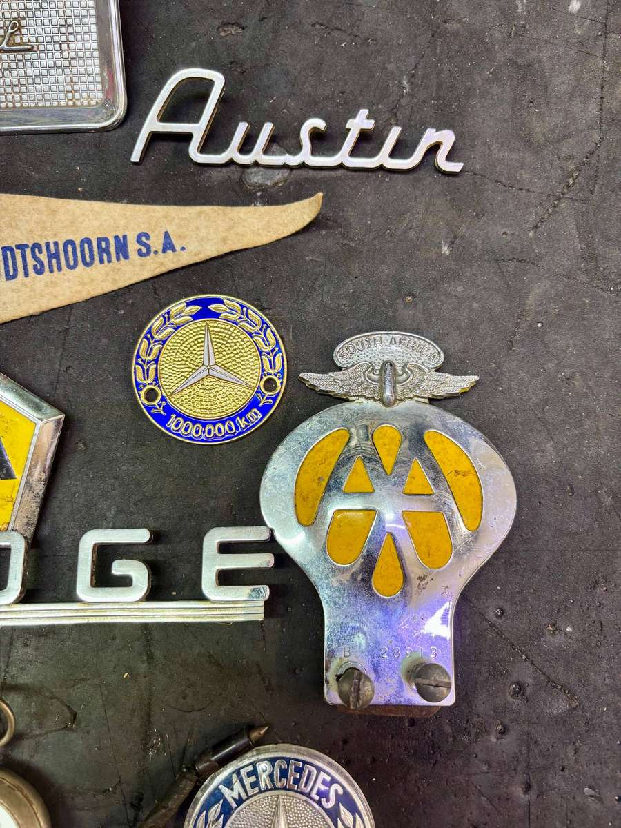 Assorted badges AA, Dodge, Opel, Austin, Mercedes Benz and more