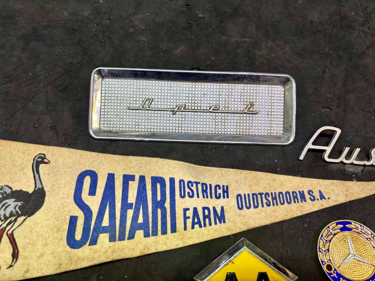 Assorted badges AA, Dodge, Opel, Austin, Mercedes Benz and more