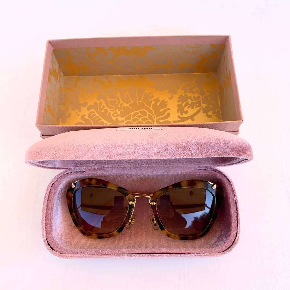 Miu Miu Cat Eye Sunglasses  Tortoise Shell / Red Arm Tips