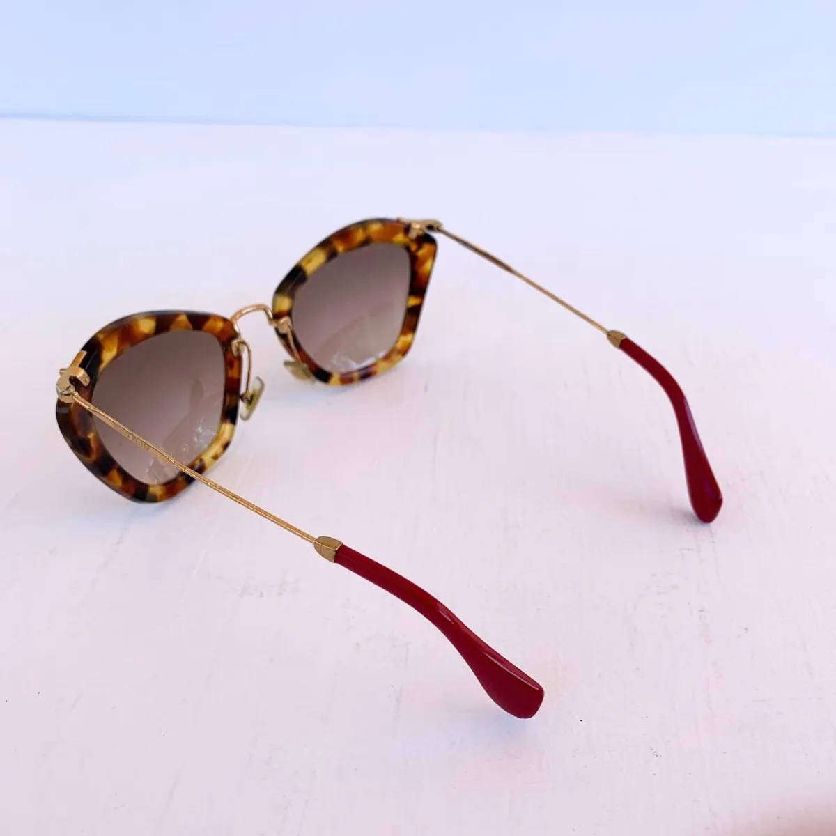 Miu Miu Cat Eye Sunglasses  Tortoise Shell / Red Arm Tips
