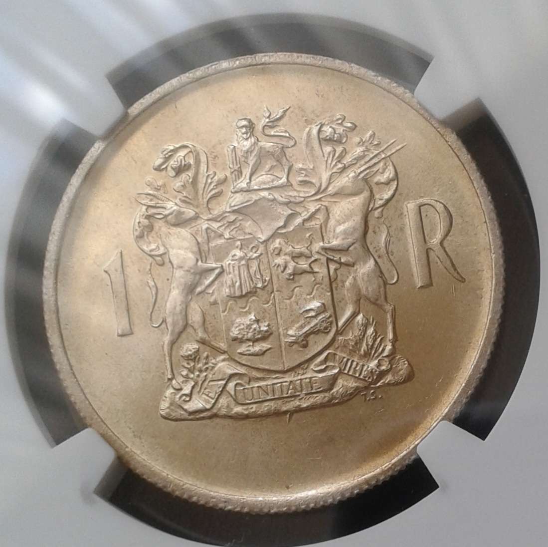 1969 Afrikaans silver R1 NGC MS62 with golden toning
