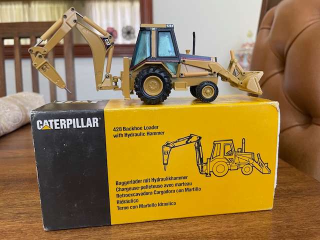 NZG - Caterpillar 428 Backhoe Loader with Hydraulic Hammer 1:50 scale