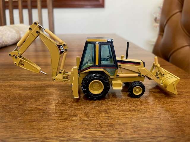 NZG - Caterpillar 428 Backhoe Loader with Hydraulic Hammer 1:50 scale