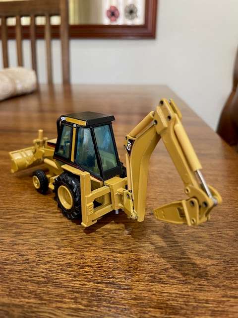 NZG - Caterpillar 428 Backhoe Loader with Hydraulic Hammer 1:50 scale