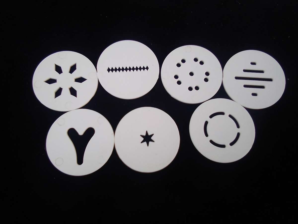 "Ideal" Biscuit and Icing Gun.  Metal trigger, tube and attachments are hard, white plastic.