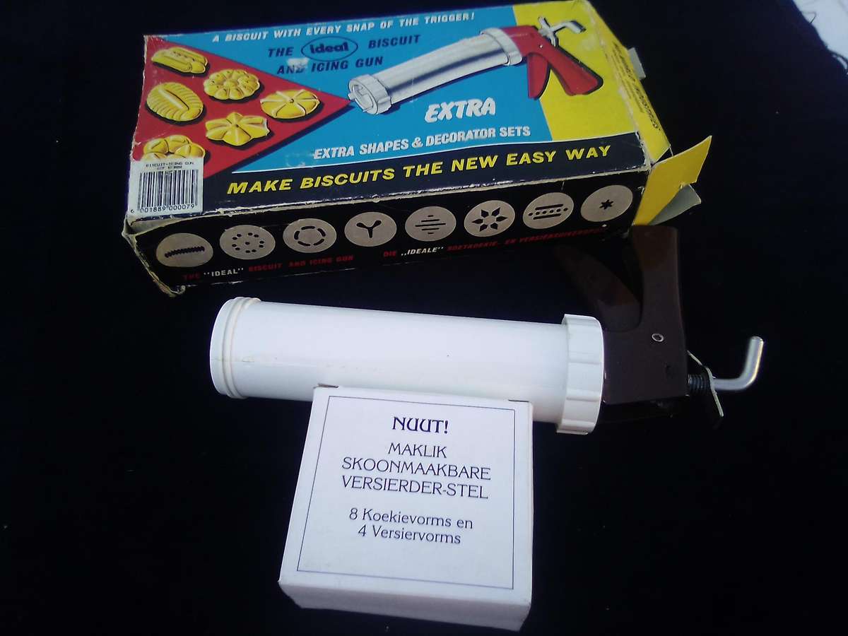 "Ideal" Biscuit and Icing Gun.  Metal trigger, tube and attachments are hard, white plastic.