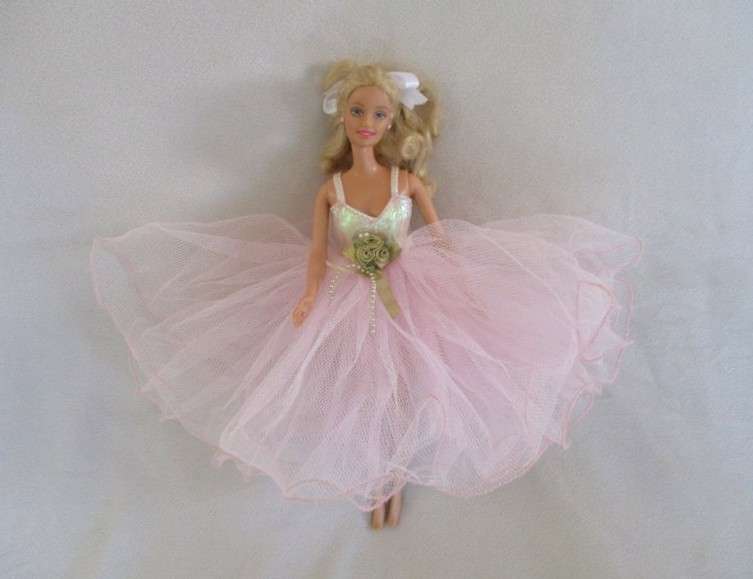 A Mattel Barbie in stunning dress with original earrings and ring - knees bend - great condition