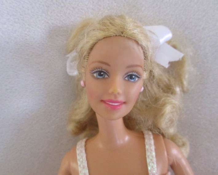 A Mattel Barbie in stunning dress with original earrings and ring - knees bend - great condition