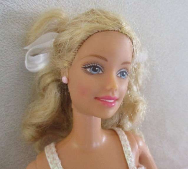 A Mattel Barbie in stunning dress with original earrings and ring - knees bend - great condition