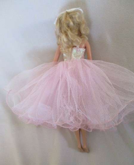 A Mattel Barbie in stunning dress with original earrings and ring - knees bend - great condition