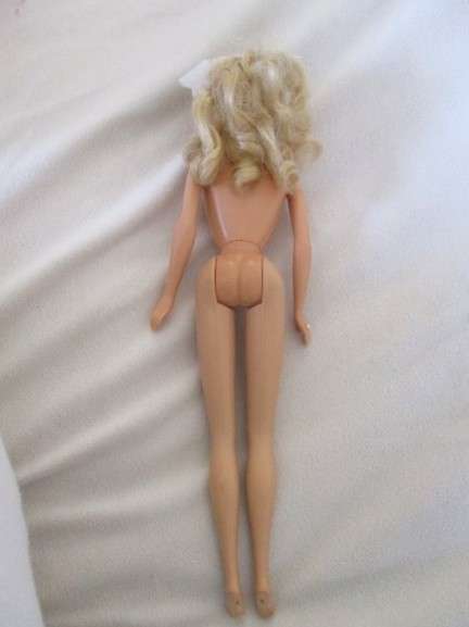 A Mattel Barbie in stunning dress with original earrings and ring - knees bend - great condition