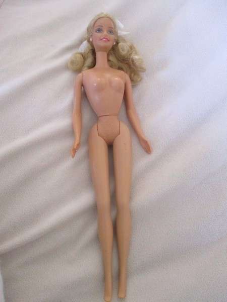 A Mattel Barbie in stunning dress with original earrings and ring - knees bend - great condition