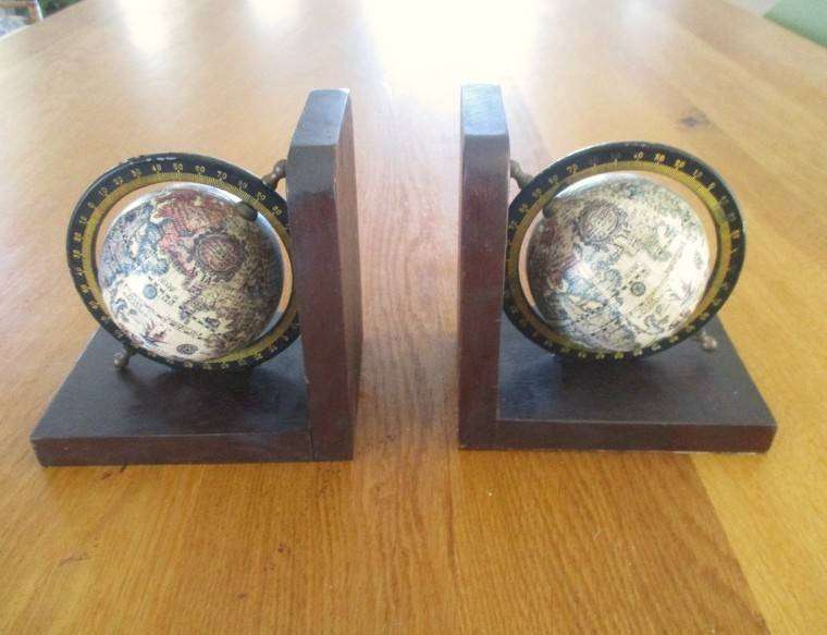Two vintage World Globe Bookends with metal globes depicting antique maps