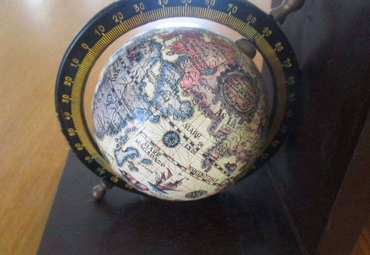 Two vintage World Globe Bookends with metal globes depicting antique maps