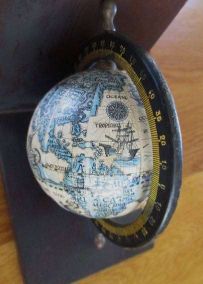 Two vintage World Globe Bookends with metal globes depicting antique maps