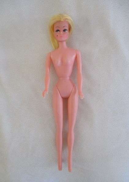 A vintage Barbie clone doll with ""cat eye" make up and beauty spot - made in Hong Kong