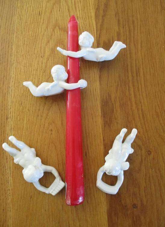 Four vintage 1960's white porcelain cherub candle huggers/climbers