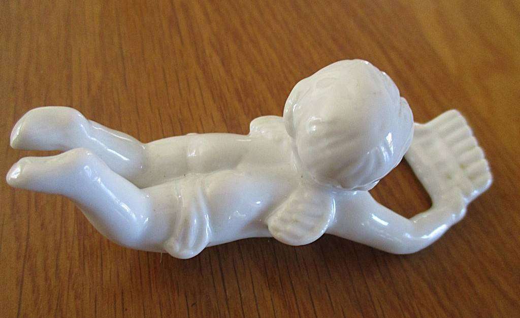 Four vintage 1960's white porcelain cherub candle huggers/climbers
