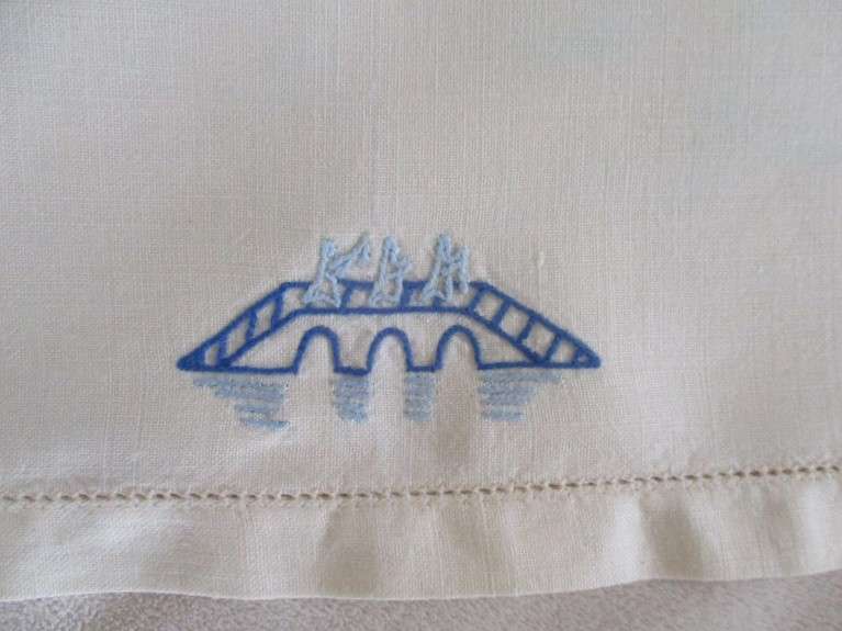 A blue and white hand embroidered tray cloth with oriental design