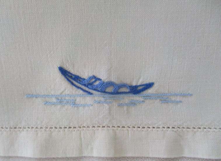 A blue and white hand embroidered tray cloth with oriental design