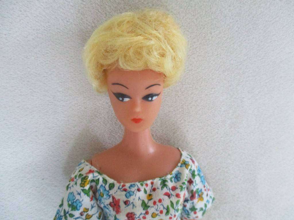A vintage Barbie clone doll with lovely "cat eye" make up and two wigs