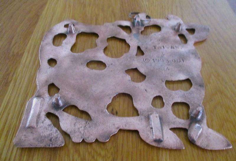 A vintage 1993 copper/copper toned trivet/pot stand with cute cow design