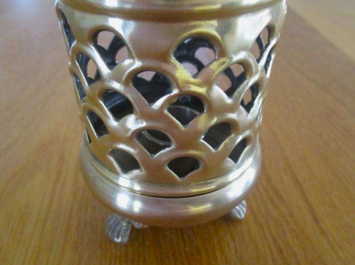 A lovely ornate footed brass lantern-style candle holder