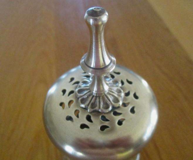 A lovely ornate footed brass lantern-style candle holder