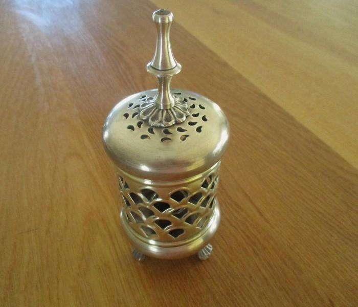 A lovely ornate footed brass lantern-style candle holder