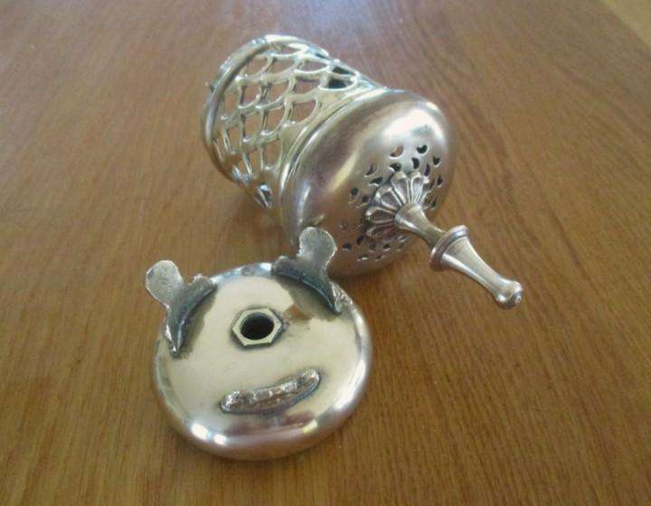 A lovely ornate footed brass lantern-style candle holder