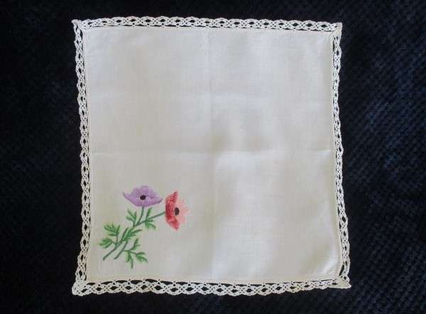 A vintage,  expertly embroidered square cloth with anemones and crocheted border