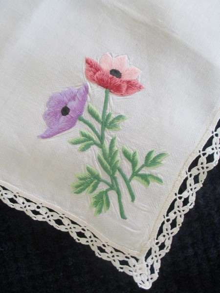 A vintage,  expertly embroidered square cloth with anemones and crocheted border