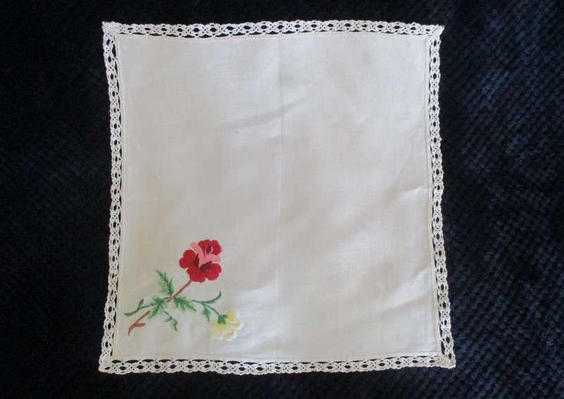 A vintage,  expertly embroidered square cloth with roses and crocheted border