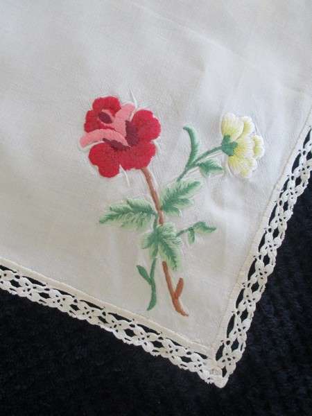 A vintage,  expertly embroidered square cloth with roses and crocheted border