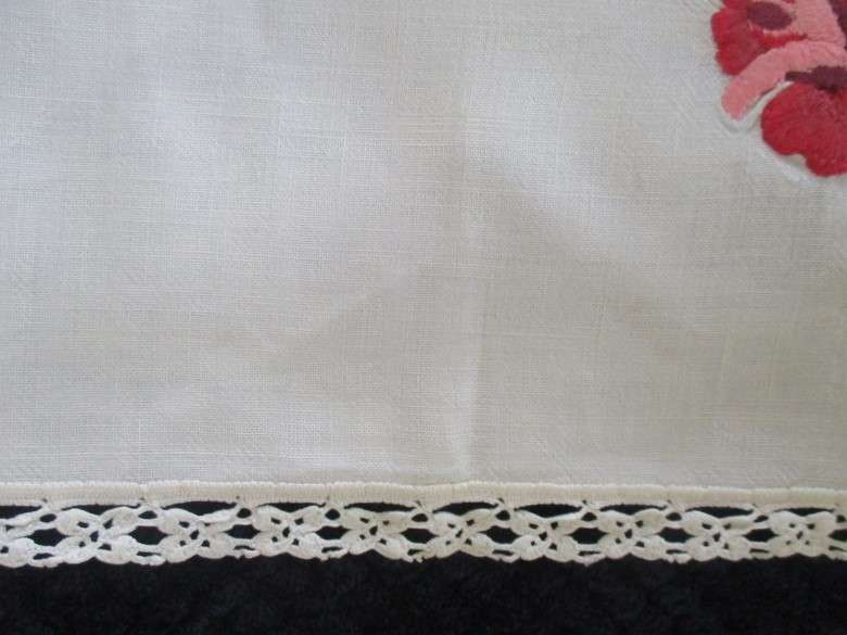 A vintage,  expertly embroidered square cloth with roses and crocheted border