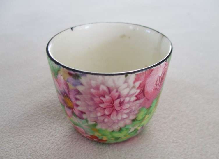 A vintage/antique Chintz egg cup marked "HP" on base