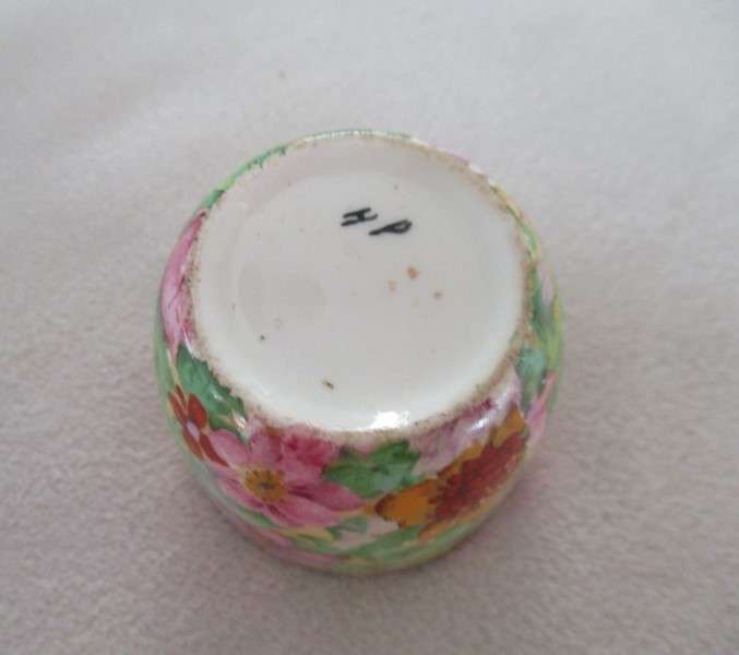 A vintage/antique Chintz egg cup marked "HP" on base