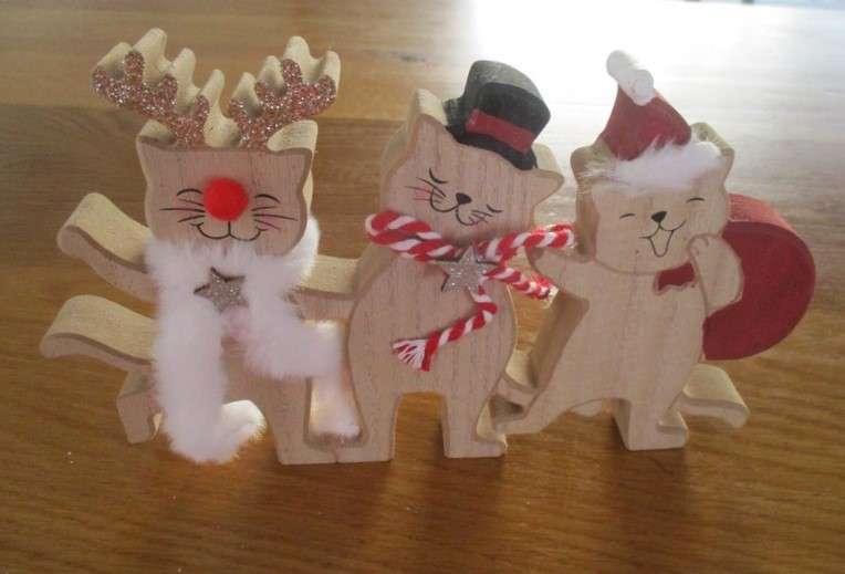 A trio of cheerful wooden cats for the festive table