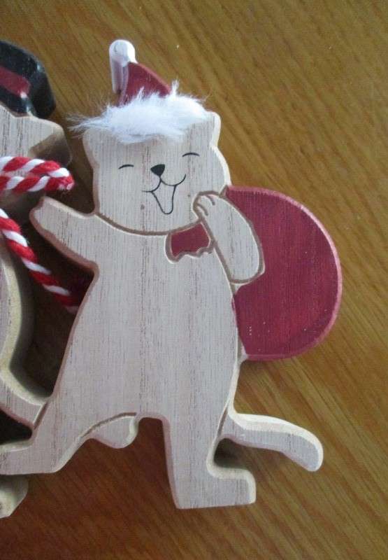 A trio of cheerful wooden cats for the festive table